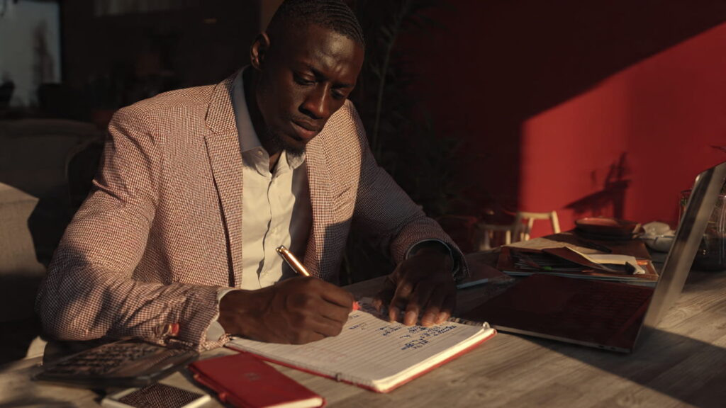 Cinematic Lagos office scene showing entrepreneur frustrated with slow-loading template website on laptop.