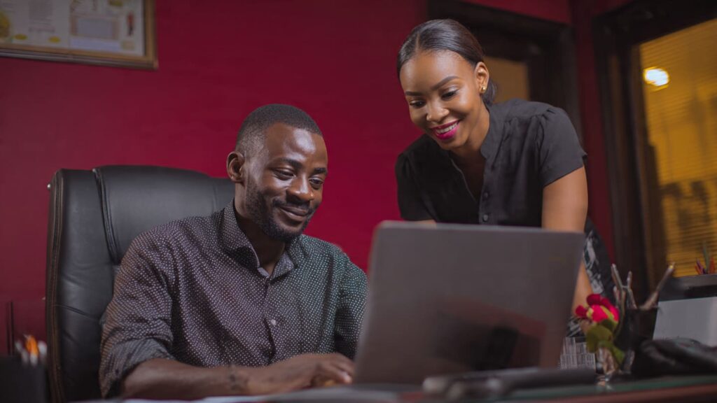 Nigerian small business owner reviewing website design proposal on laptop in Lagos Nigeria 2026